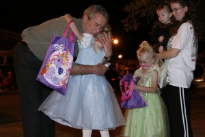 President George W. Bush hugging a trick-or-treater.